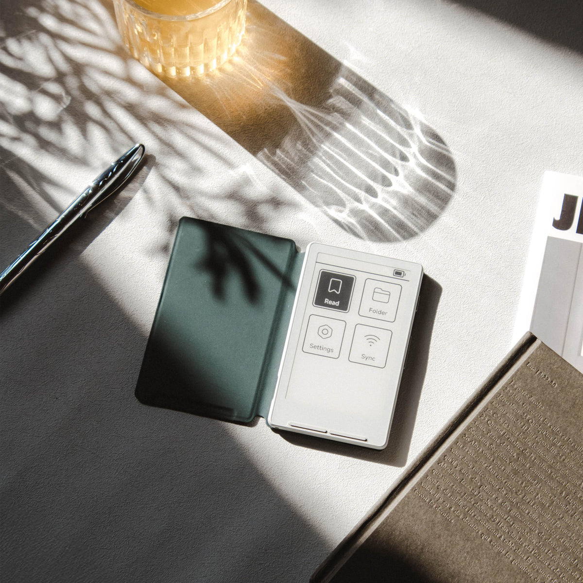 Green magnetic phone case open with small white control unit and buttons